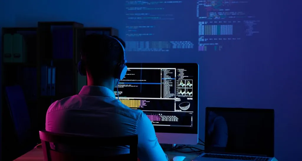 vista-posterior-programador-trabajando-toda-noche-1024×546